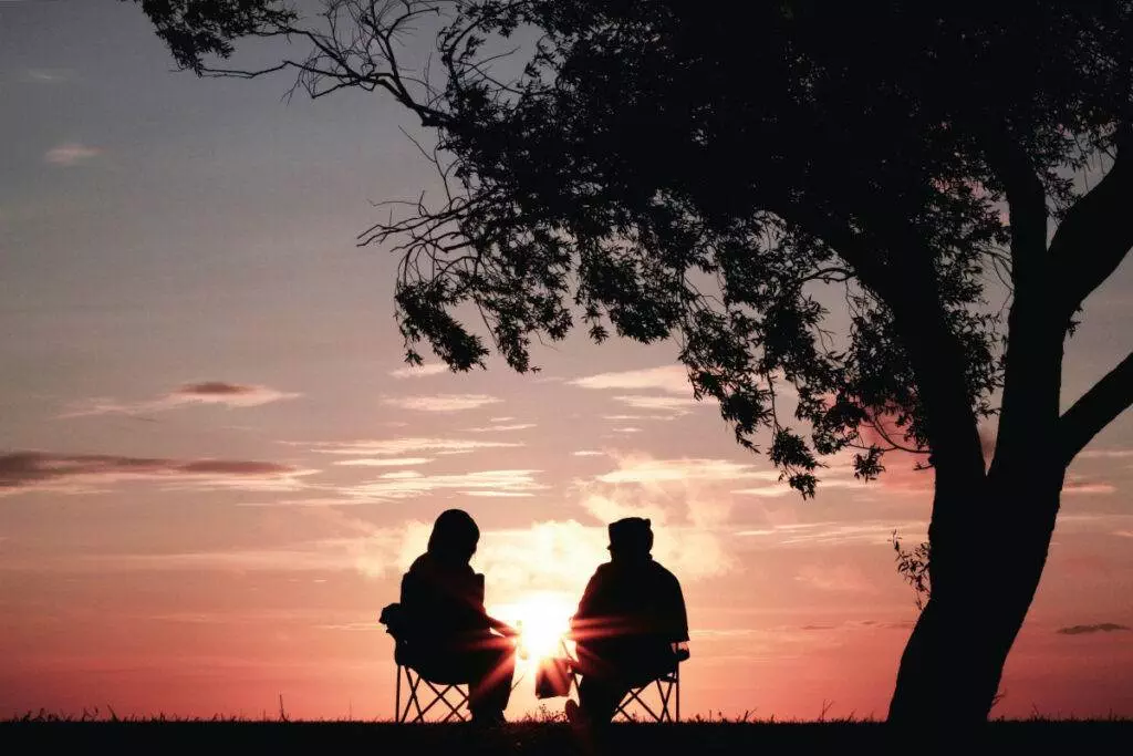 A couple sitting together watching the sunset